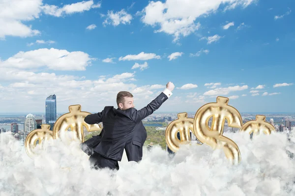 Businessman is flying over the central park in New York through the cloud and dollar signs — Stock Photo, Image