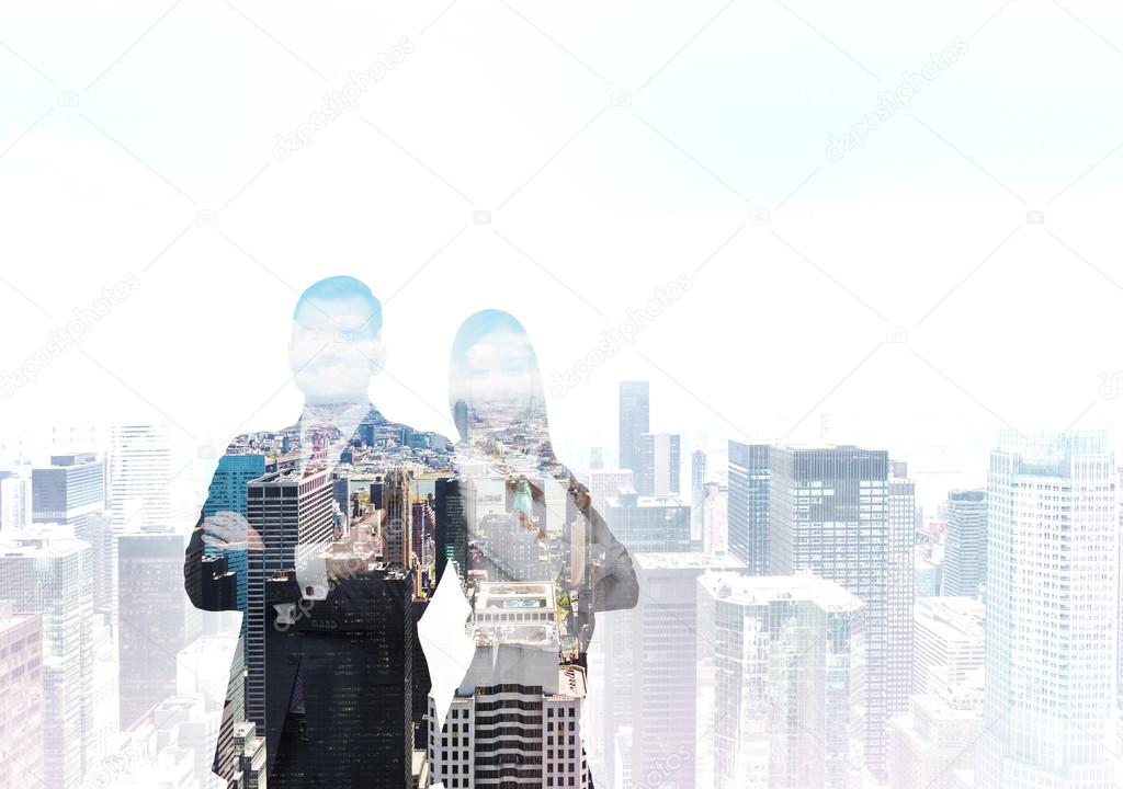 The silhouette of the couple of professionals over the New York City. A concept of international consulting.