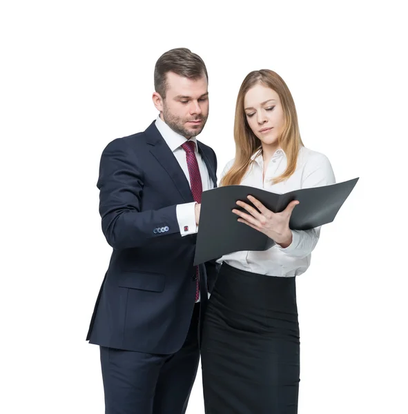 A young business couple are looking at the black document case. A concept of the teamwork. Isolated. — Stock Photo, Image