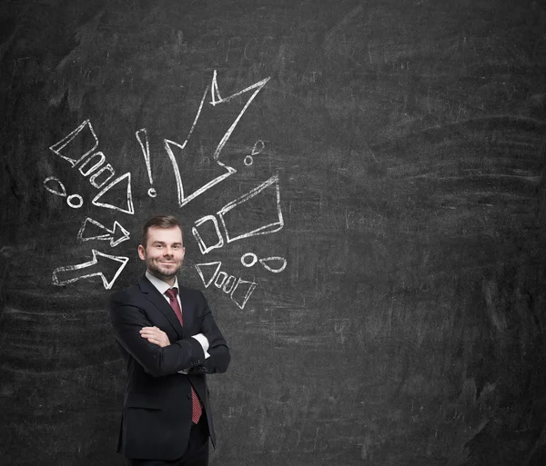 Confident handsome businessman surrounded by drawn arrows pointing to him. — 图库照片