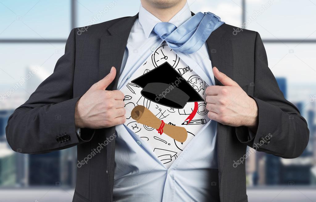 Young student is tearing the shirt. Graduation attributes are drawn on the chest. The concept of the graduation.