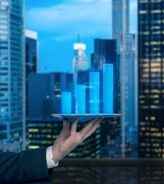 Analyst's hand is holding a gadget with bar chart projection of the expected revenue of the company. clipart