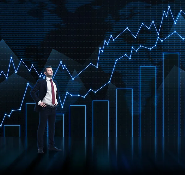 Successful businessman is looking at the future perspectives. The chart of the revenue growth on the backround. — Stock Photo, Image