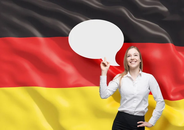 Frau zeigt auf die leere Gedankenblase. Deutsche Flagge als Hintergrund. — Stockfoto