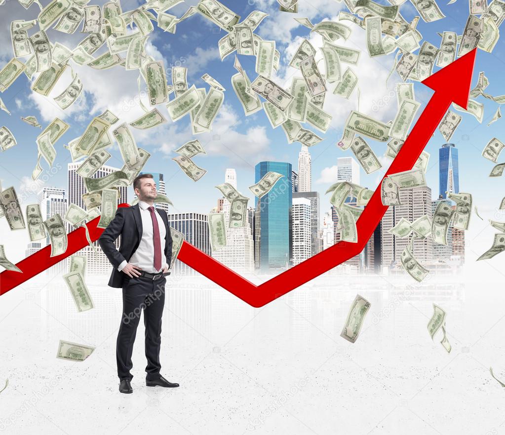 Full-length confident businessman stands among falling dollar bills from the sky. Red arrow is going up as a symbol of the growth in economy. New York sketch background.