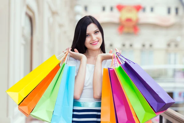 Full-length happy smiling lady with a lot of colourful shopping bags from  the fancy shops. Luxury shopping venue. Stock Photo by ©denisismagilov  74600157