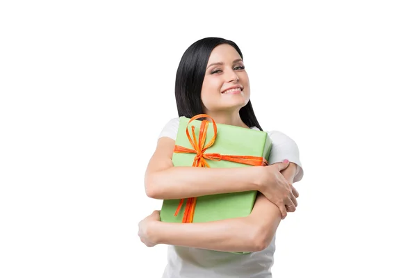 Happy brunette girl hugs the gift box. Isolated. — Stock Photo, Image