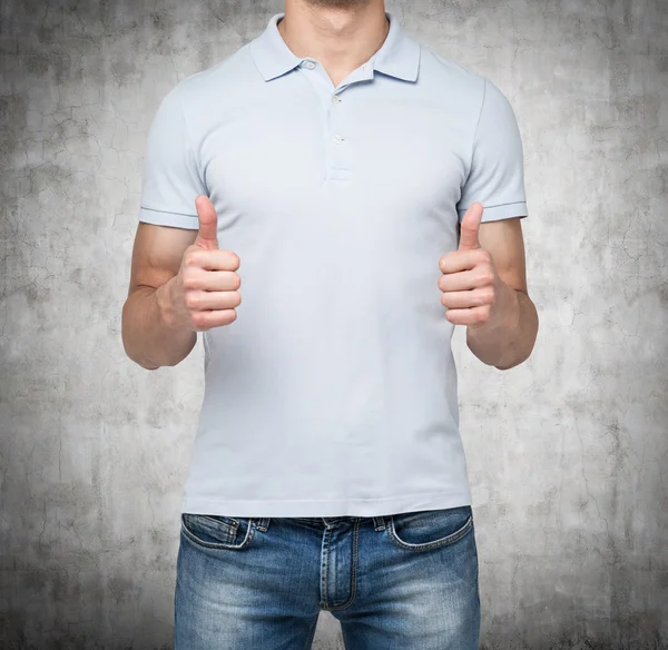 A person with thumbs up. Concrete background. — Stock Photo, Image