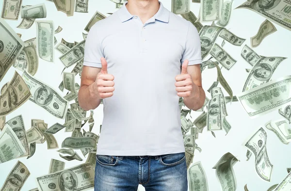 A person with thumbs up. Dollar notes are falling down from the ceiling. — Stock Photo, Image