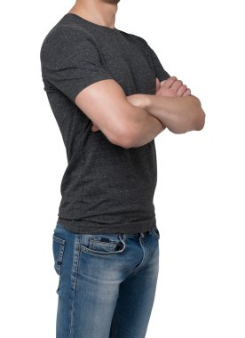Side view of a man in a dark grey t-shirt with crossed hands. Isolated