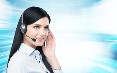 Portrait of smiling cheerful support phone operator in headset. Modern blue background.