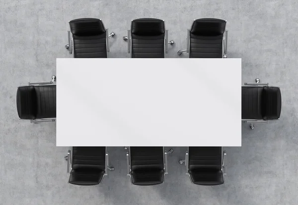 Top view of a conference room. A white rectangular table and eight black leather chairs around. 3D interior. — ストック写真