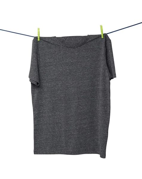 Close up of a dark grey t-shirts on the rope. Isolated. — Stok fotoğraf