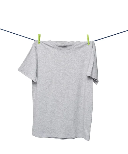 Close up of a grey t-shirts on the rope. Isolated. — Stok fotoğraf