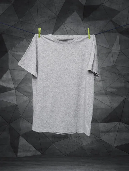 Close up of a grey t-shirts on the rope. Contemporary background. — Stok fotoğraf