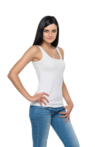 Close up of brunette girl in denims and white tank top. Isolated. — Stockfoto