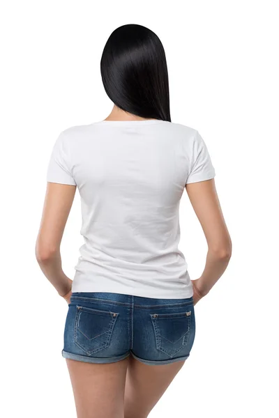 Rear view of the brunette girl in denim shorts and white t-shirt. Isolated. — Stockfoto