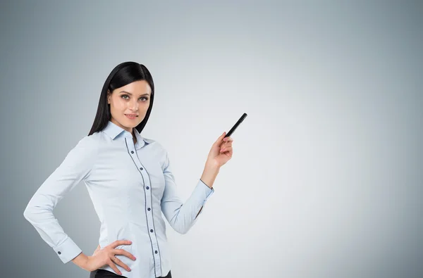 A brunette is pointing out something. A concept of business presentation. — Φωτογραφία Αρχείου