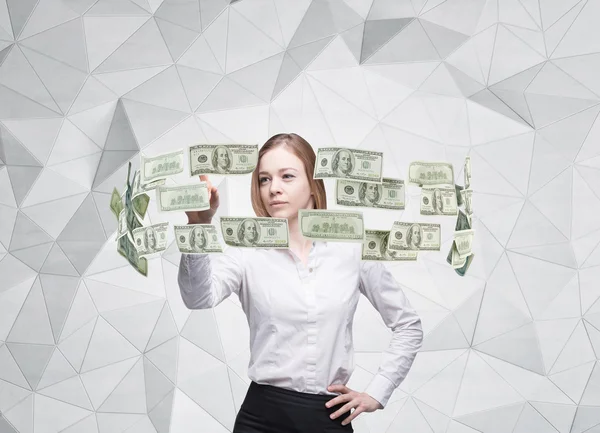 Young lady is controlling cash flow of the dollar notes. Contemporary background. — Stock fotografie