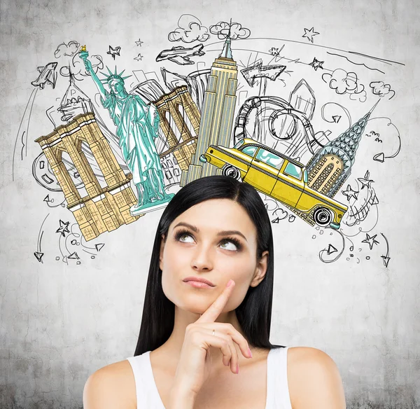 A portrait of a pensive brunette lady in a white tank top. Visiting of USA concept. Concrete background with a colourful sketch of the most famous places in New York. — Zdjęcie stockowe