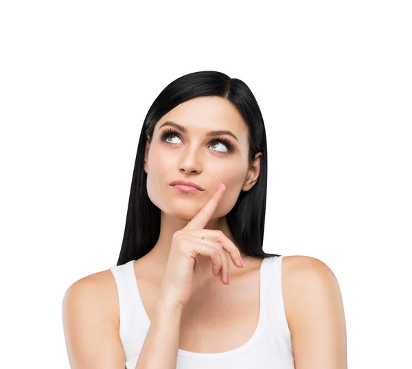 A portrait of a pensive brunette lady in a white tank top. Isolated. — Stockfoto