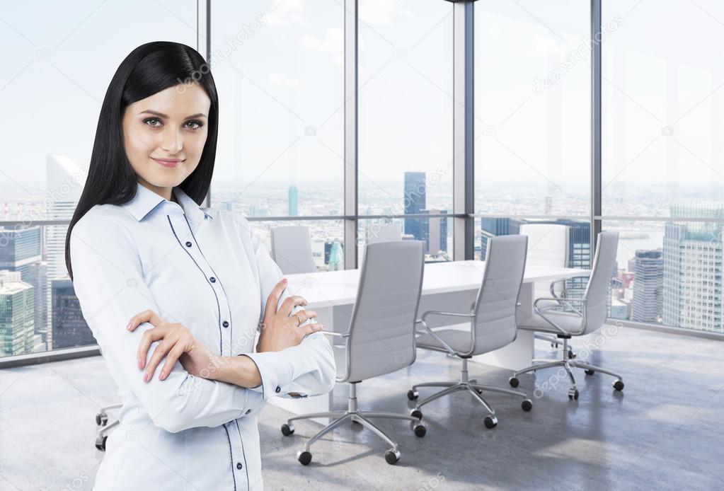 Beautiful brunette in a corner conference room. Modern office with huge windows and amazing New York panoramic view.
