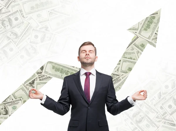 Meditative businessman. Dollar notes background with the growing arrow made from dollar notes. — Stock Photo, Image