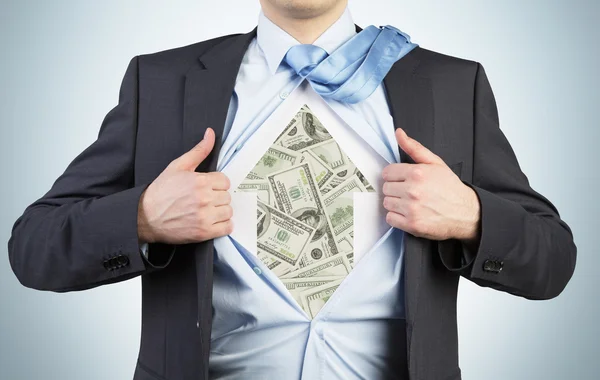 Businessman is tearing the shirt on the chest. Dollar notes under the shirt. The concept of the business soul. — Stock Photo, Image