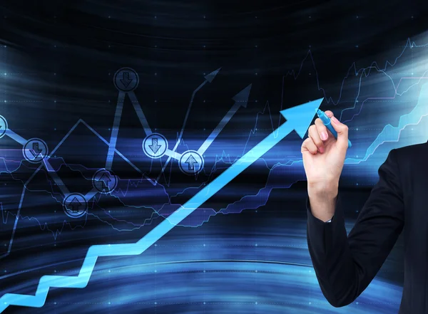 A hand is drawing a growing arrow on the glass scree, Blue dark background with financial graphs. — Stock Photo, Image