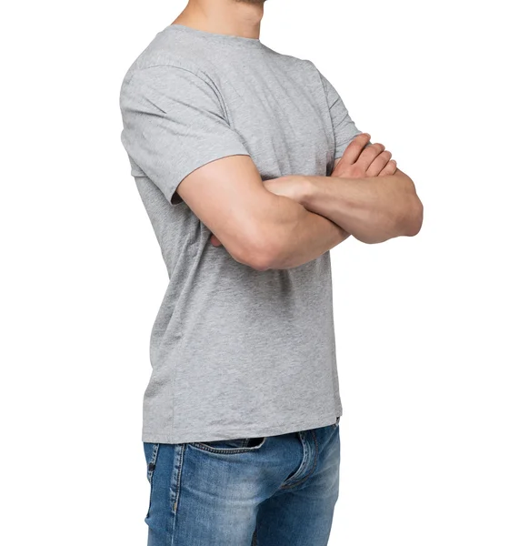 Side view of the young man in a grey t-shirt with crossed hands. Isolated. — Stock fotografie