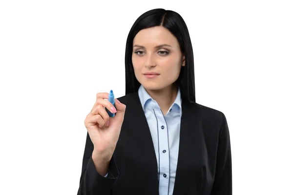 A brunette woman is writing something on the copy space. Isolated on white background. — Stockfoto