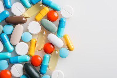 Composition with colourful pills and light grey background.