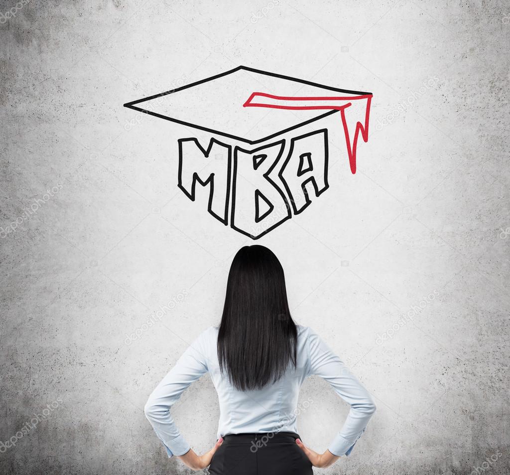Rear view of the young brunette lady who is thinking about MBA degree. Drawn a graduation hat on the concrete background .