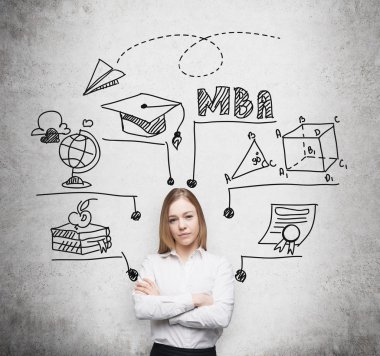 Young beautiful lady with crossed hands is going to get the master's degree in business administration. A concept of the MBA degree. Drawn educational icons on the concrete wall.