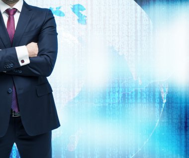 Businessman with crossed hands. Digital world with binary code on the background. Elements of this image furnished by NASA.