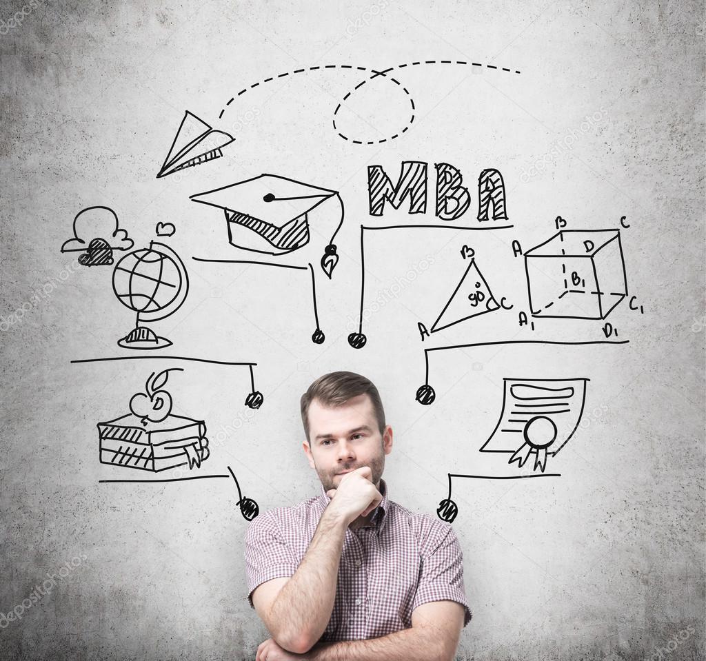 A young prosperous man is thinking about MBA degree. Educational chart is drawn behind him. A concept of further business education. Concrete background.