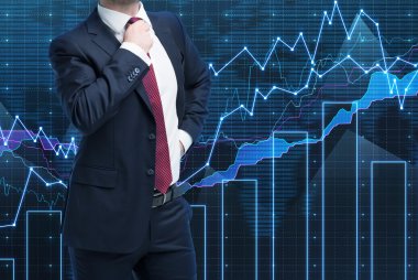 Closeup of successful portfolio manager in formal suit. A concept of decision making process in finance. Forex chart on the background.