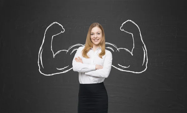 A beautiful lady in formal clothes with drawn powerful hands. Black chalkboard background.