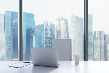 A workplace in a modern panoramic office with Singapore view. A white table, white leather chair. Laptop, writing pad and a cap of coffee are on the table. Office interior. 3D rendering.