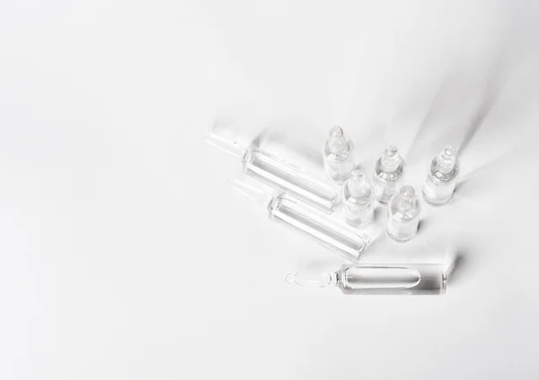 Vista superior del juego de ampollas de vidrio de sello roto con medicina líquida sobre fondo blanco . —  Fotos de Stock