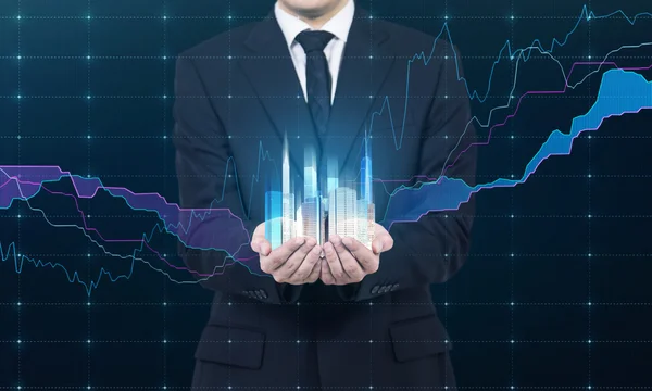 Eine Person hält ein Hologramm von Wolkenkratzern als Symbol für finanziellen Erfolg. Devisendiagramm als Teil des Hologramms. — Stockfoto