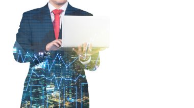 A transparent silhouette of a man in formal suit who is looking for some data in the laptop. Panorama of evening New York city and financial charts on the background.