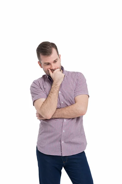 Young man in casual shirt holds his chin and thinks about the best solution of the problem.Isolated on white background. — Zdjęcie stockowe