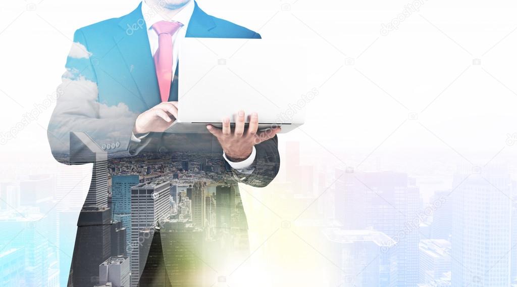 A transparent silhouette of a man in formal suit who is looking for some data in the laptop. Panorama of New York city on the background.