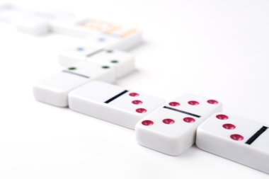 White domino pieces with colorful points. White background.