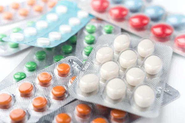 Pile of colorful medicine pills in blister packs — Stok fotoğraf