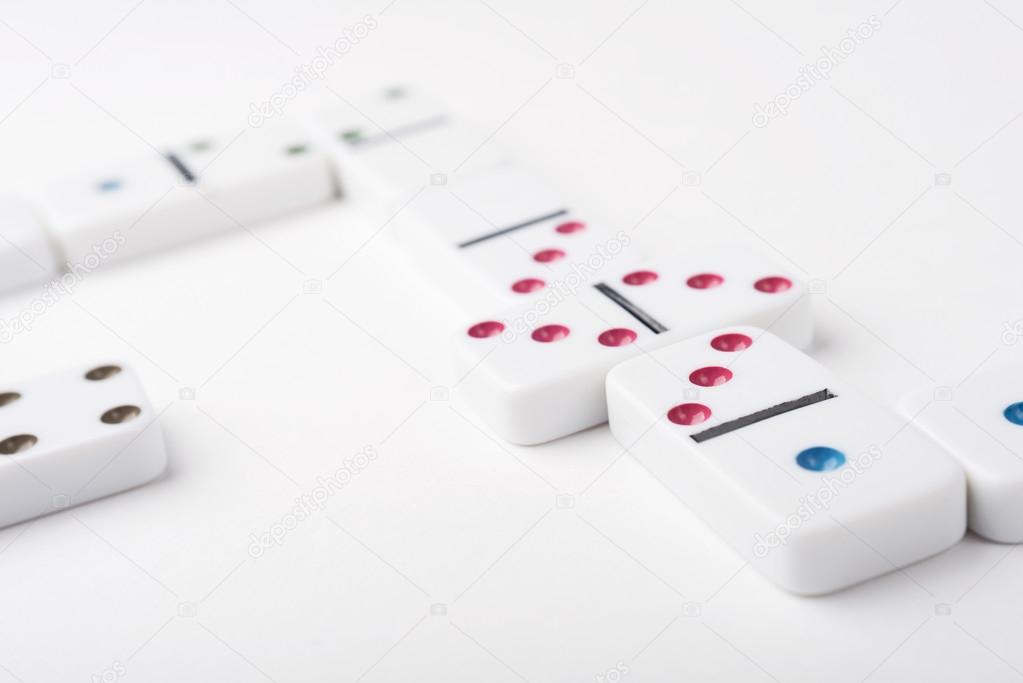 White domino pieces with colorful points. White background.