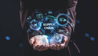 Digital supply chain concept with glowing hologram interface, logistics icons, and global network above open human hands on a dark blurred background