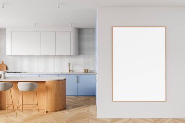 Ahşap ada, pastel dolaplar ve beyaz duvarda ahşap çerçeveli boş poster modeliyle çağdaş mutfak içi. 3B Hazırlama