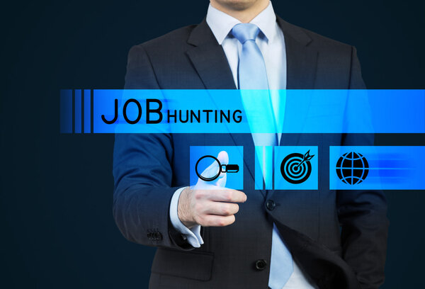 A person in a suit is pushing the hologram button which is symbolised the search. A concept of the Job hunting. Dark background.